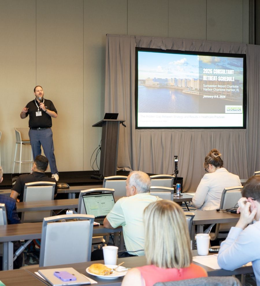 Nathan Bush teaching a live training in front of a seated audience